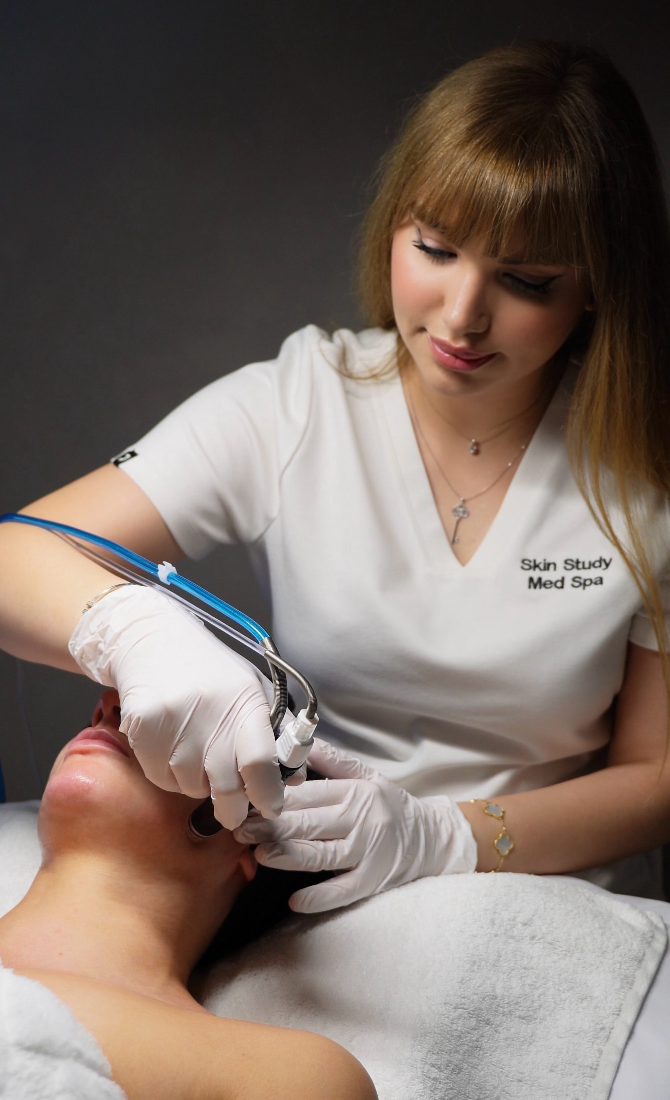 Licensed esthetician Leila performing a customized HydraFacial treatment at Skin Study Med Spa in Plano, TX