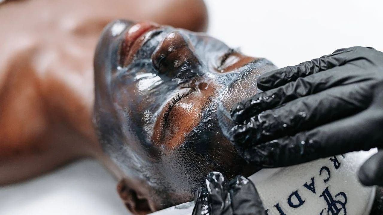 Gloved esthetician applying a professional Circadia treatment mask during a facial at Skin Study Med Spa in Plano, TX